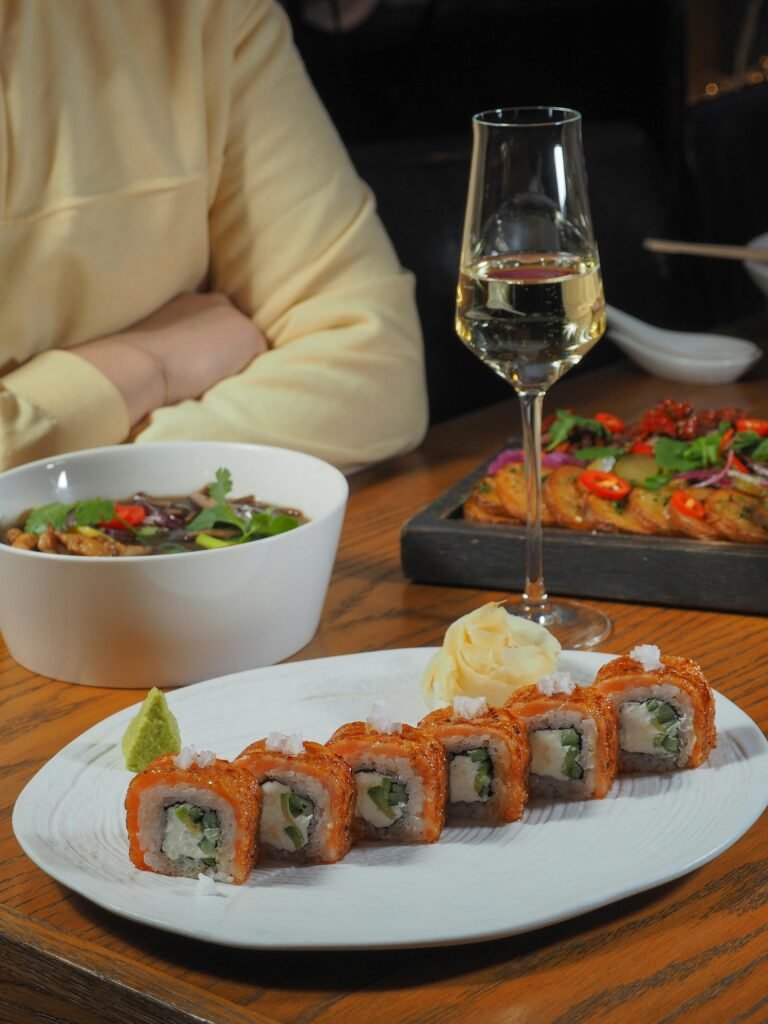 Sushi on a Plate and a Glass of White Wine