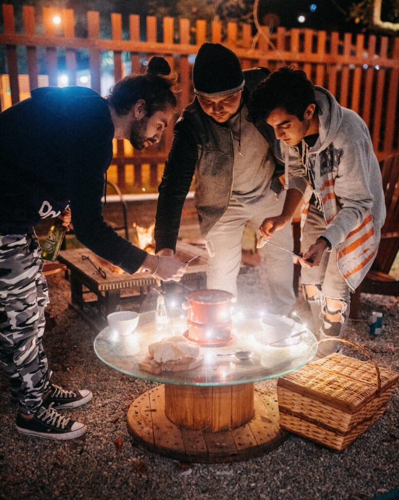 Friends having fondue patty in yard