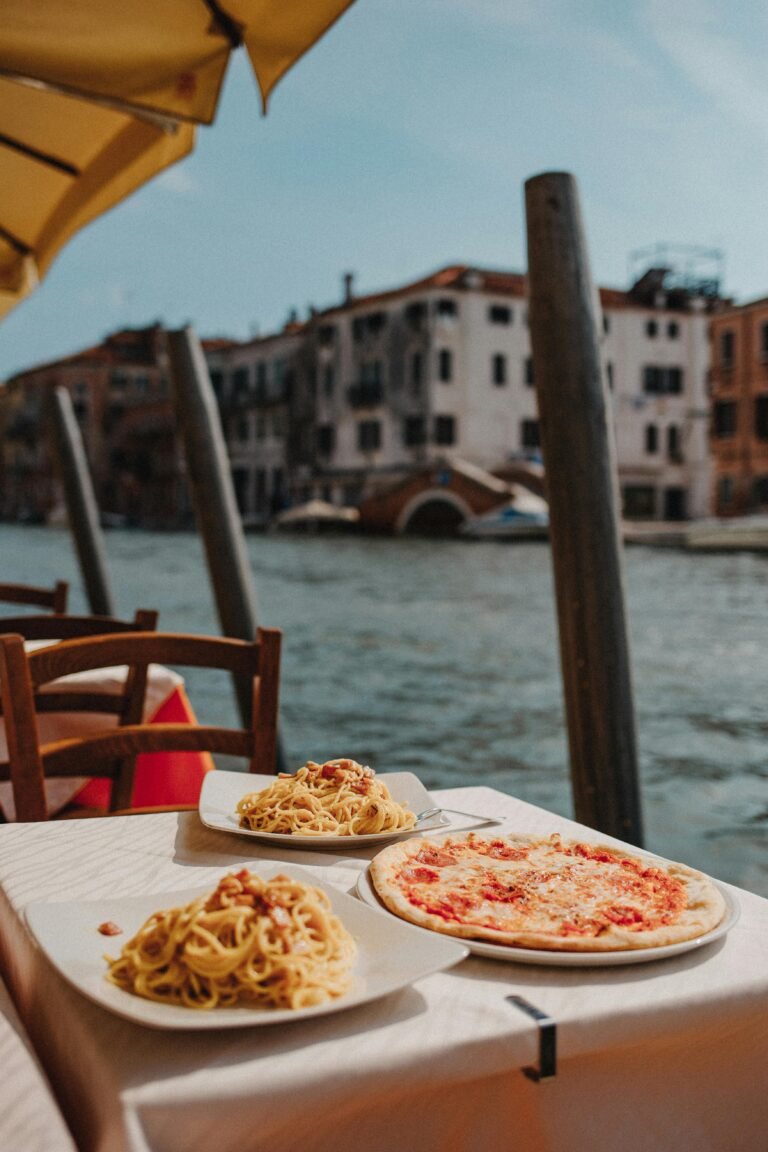 Pizza and Pasta which are famous dish on italy on White Ceramic Plate