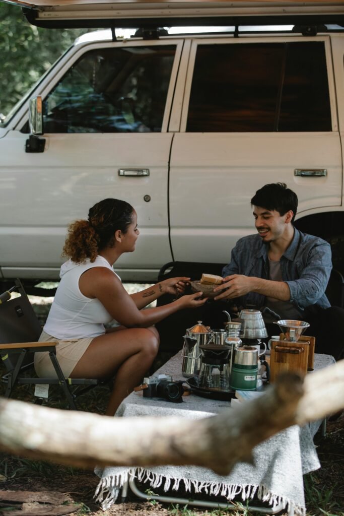 positive-young-diverse-couple-having-lunch-during-holiday-in a road trip