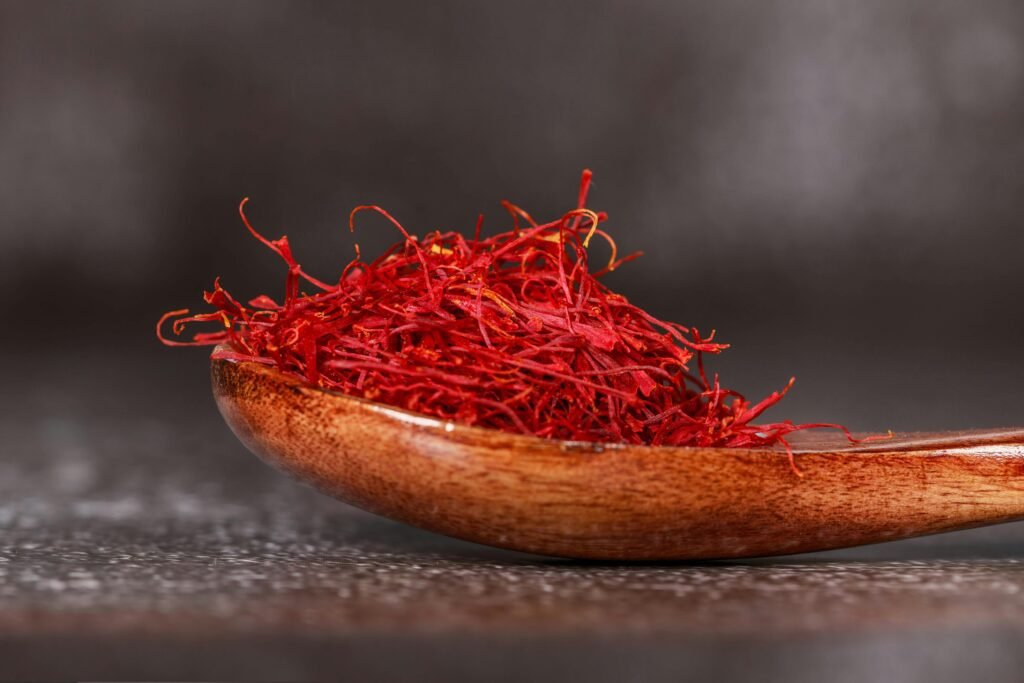 Red Saffron Spice on Brown Wooden Spoon