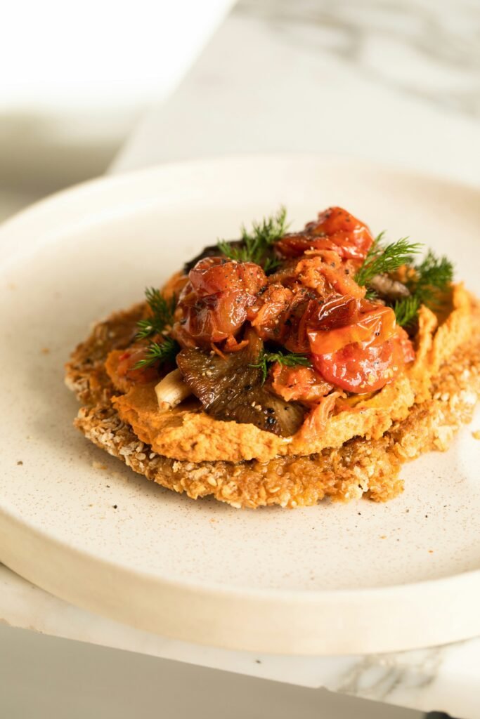 Vegan Schnitzel with Tomato Hummus, Oyster Mushrooms, tomato confit & herbs by Karolin Baitinger, Bakd&Raw recipe