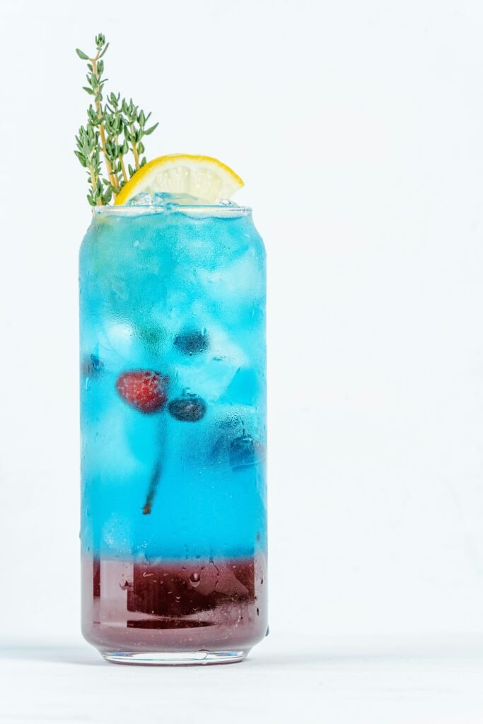 A Refreshing Electric Lemonade Drink with Berries and Lemon Slice