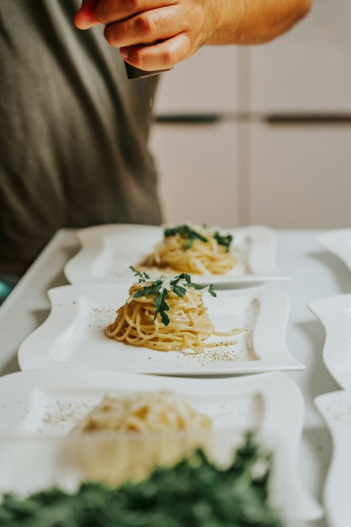 a-person-holding-a-knife-over-a-plate-of-Cacio E Pepe