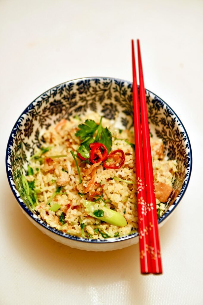 Red Chopsticks on Bowl with Couscous Meal