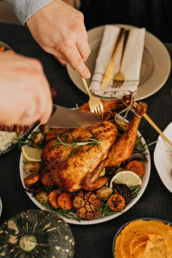 Person Cutting Turkey on Thanksgiving Table and making Turkey Wings Recipe